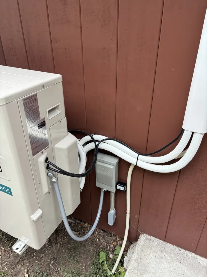Finished ductless outdoor wiring and neatly routed insulated refrigerant line cover