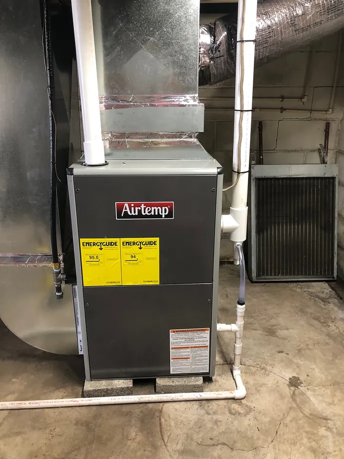 AirTemp indoor furnace and attached ductwork in a residential basement