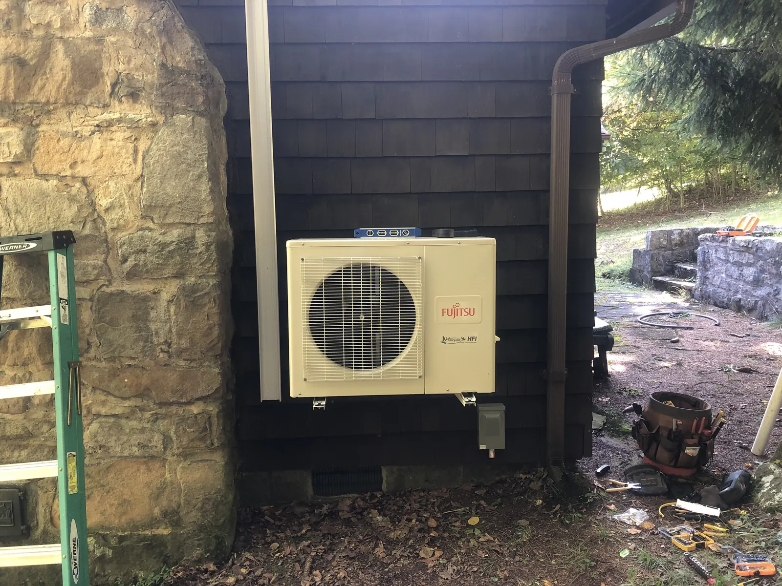 Fujitsu outdoor ductless system installed against house siding